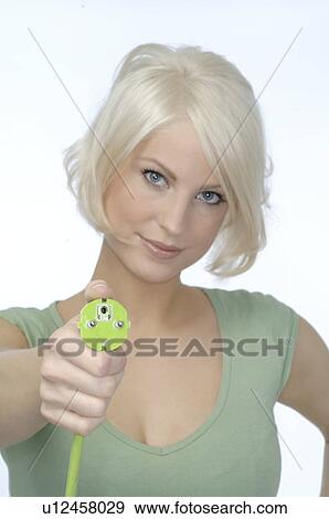 Teenage girl holding green plug connector View Large Photo Image Stock Photo - Teenage girl holding green plug connector. Fotosearch