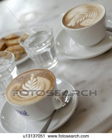 Two cups of white coffee with nice pattern View Large Photo Image Stock Image - Two cups of white coffee with nice pattern. Fotosearch