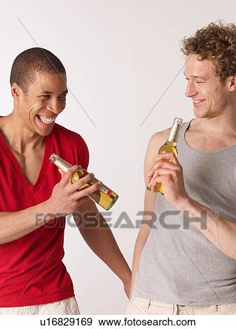 Stock Photo - Two friends drinking beer together. Fotosearch