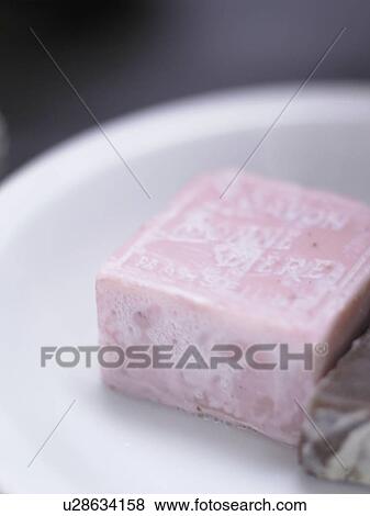 White plate with light violet soap bar (close-up) View Large Photo Image Stock Photo - White plate with light violet soap bar (close-up). Fotosearch