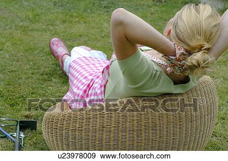 Woman having a break from gardening View Large Photo Image Stock Photo - Woman having a break from gardening. Fotosearch
