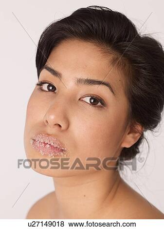 Woman having salt exfoliation on her mouth View Large Photo Image Stock Photo - Woman having salt exfoliation on her mouth. Fotosearch