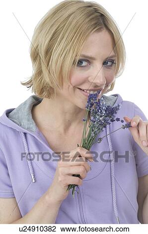 Stock Image - Woman holding lavender. Fotosearch