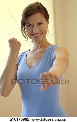Stock Image - Woman in sportswear doing aerobic exercises. Fotosearch