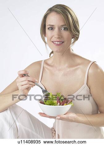 Woman is eating salad View Large Photo Image Stock Photography - Woman is eating salad. Fotosearch