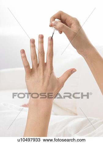 Woman is varnishing her nails View Large Photo Image Stock Image - Woman is varnishing her nails. Fotosearch