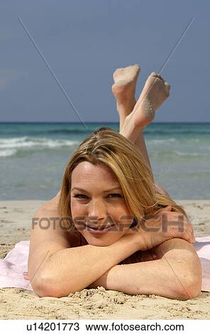 Woman lying on the beach View Large Photo Image Stock Image - Woman lying on the beach. Fotosearch