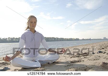 Woman making yoga on the beach View Large Photo Image Picture - Woman making yoga on the beach. Fotosearch