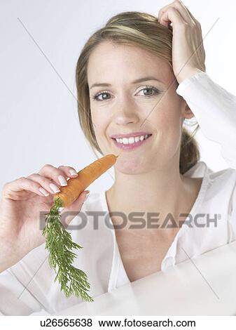 Woman with a carrot View Large Photo Image Stock Photo - Woman with a carrot. Fotosearch