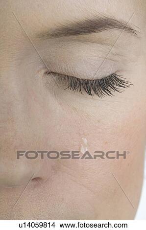 Woman with a teardrop on her cheek View Large Photo Image Picture - Woman with a teardrop on her cheek. Fotosearch