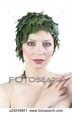 Stock Image - Woman with leaves on her head and a snail on her neck. Fotosearch