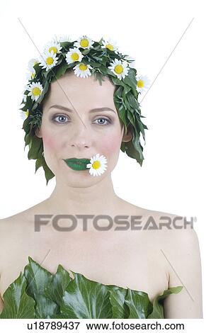 Woman with leaves on her head and a blossom between her green lips View Large Photo Image Stock Photo - Woman with leaves on her head and a blossom between her green lips. Fotosearch
