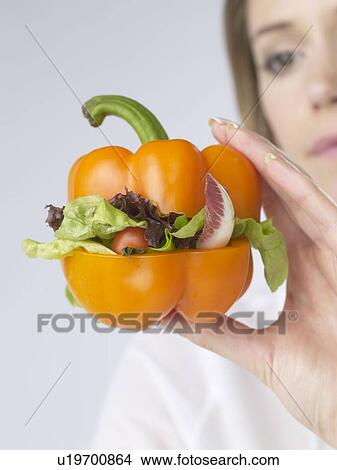 Picture - Woman with pepper vegetable-burger. Fotosearch