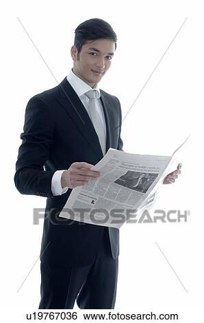 Young businessman reading newspaper View Large Photo Image Stock Photograph - Young businessman reading newspaper. Fotosearch