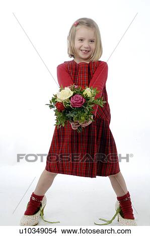 Picture - Young girl in large shoes handing a bunch of Flowers. Fotosearch