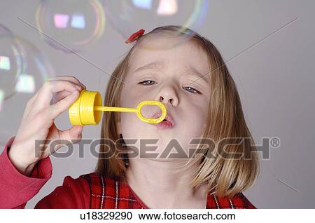 Young girl making soap bubbles View Large Photo Image Stock Image - Young girl making soap bubbles. Fotosearch