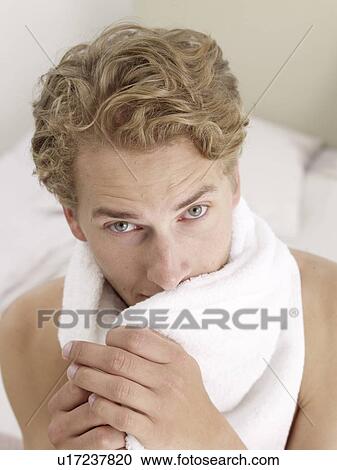 Stock Image - young man with a towel. Fotosearch