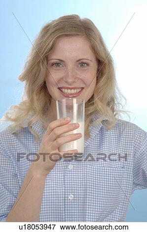 Stock Photo - Young Woman drinking a Glass of Milk. Fotosearch