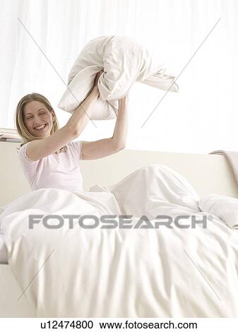 Stock Image - young woman in bed. Fotosearch