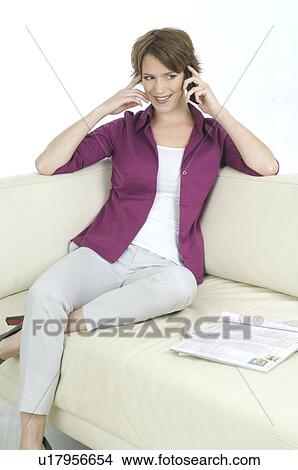 Picture - Young woman in casual wear on the telephone. Fotosearch