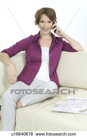 Stock Photo - Young woman in casual wear on the telephone. Fotosearch
