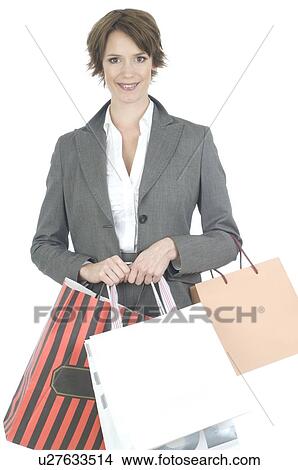 Picture - Young woman shopping in business dress. Fotosearch