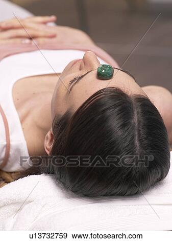 Stock Photo - Young woman with malachite on her front. Fotosearch