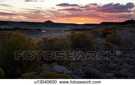 Asphalt road leading into dramatic sunset, with wild sage along roadside, and grey-pink-orange sky at twilight, Utah View Large Photo Image Stock Image - Asphalt road leading into dramatic sunset, with wild sage along roadside, and grey-pink-orange sky at twilight, Utah. Fotosearch