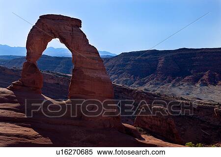 Delicate Arch in early morning sunlight against blue sky, mountain range beyond, Arches, Utah, View Large Photo Image Stock Photography - Delicate Arch in early morning sunlight against blue sky, mountain range beyond, Arches, Utah,. Fotosearch