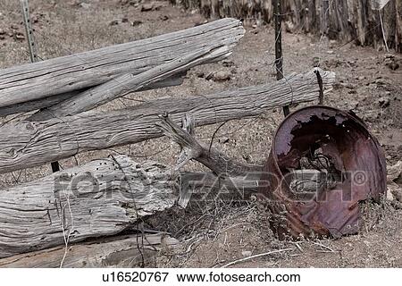 Desaturated close up image of old wooden fence pieces and rusty metal can lying on ground in desert, Utah View Large Photo Image Stock Photo - Desaturated close up image of old wooden fence pieces and rusty metal can lying on ground in desert, Utah. Fotosearch
