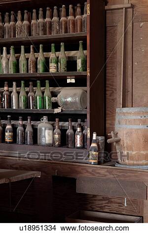 Drinking saloon as seen from inside with beer bottles behind bar, desaturated image, Bodie pioneer village, California View Large Photo Image Picture - Drinking saloon as seen from inside with beer bottles behind bar, desaturated image, Bodie pioneer village, California. Fotosearch