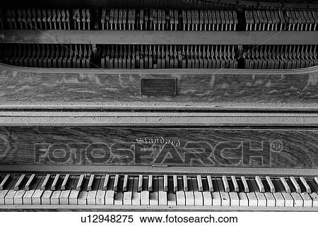 Stock Photography - Drinking saloon as seen from inside with detail of piano, desaturated image, Bodie pioneer village, California. Fotosearch