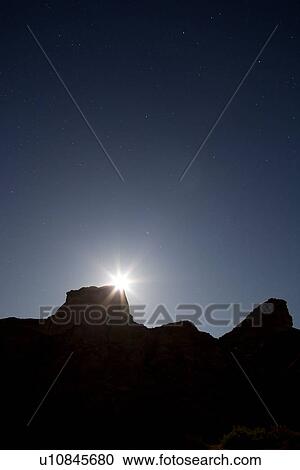 Full moon peering over butte silhouetted in Reds Canyon, forming "moonstar", clear indigo sky with stars, Utah View Large Photo Image Stock Image - Full moon peering over butte silhouetted in Reds Canyon, forming "moonstar", clear indigo sky with stars, Utah. Fotosearch