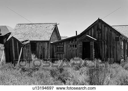 Stock Photo - Group of wooden houses with wild sage foreground, desaturated image, Bodie pioneer village, California. Fotosearch