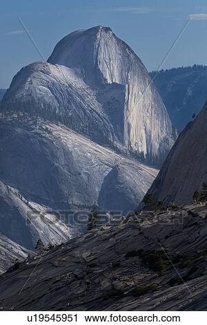 Stock Image - Half Dome seen from Olmsted Point in late afternoon summer light sheen on rockface, Yosemite. Fotosearch