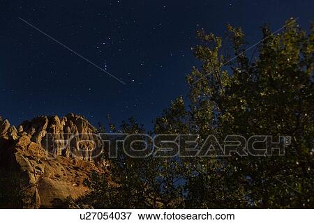 Mountain butte and tree lit by moonlight, against indigo starry sky, Utah View Large Photo Image Stock Photo - Mountain butte and tree lit by moonlight, against indigo starry sky, Utah. Fotosearch