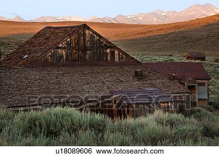 Old wooden house at dawn, with Sierra Nevada snow-tipped mountain range in distance, blue sky, sage brush foreground, Bodie pioneer village, California View Large Photo Image Stock Photograph - Old wooden house at dawn, with Sierra Nevada snow-tipped mountain range in distance, blue sky, sage brush foreground, Bodie pioneer village, California. Fotosearch