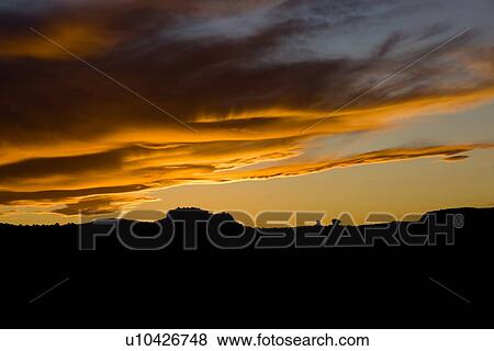 Stock Photo - Panorama at Panorama Point, Utah, with dramatic red-purple lenticular cloud formation over silhouetted skyline. Fotosearch