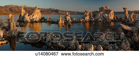Stock Photo - Panorama image of ring of tufa formations, reflected in water, summer, at sunrise, Mono Lake, California. Fotosearch