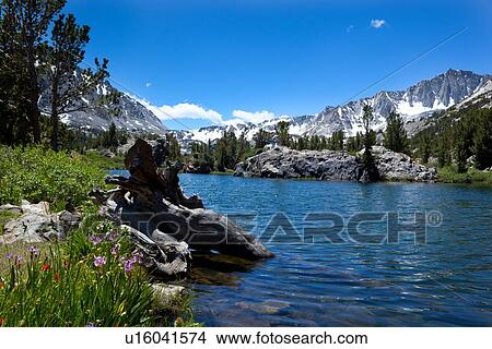 Picture - Panorama of clear blue lake against snow-tipped Sierra Nevada mountain range, on sunny summer morning. Fotosearch