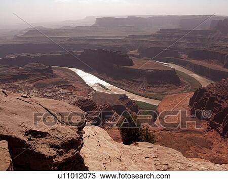 Panorama over Dead Horse Point, with U - shaped silver curve of Colorado River below on sunny fall morning, and mountains beyond, Utah View Large Photo Image Stock Image - Panorama over Dead Horse Point, with U - shaped silver curve of Colorado River below on sunny fall morning, and mountains beyond, Utah. Fotosearch
