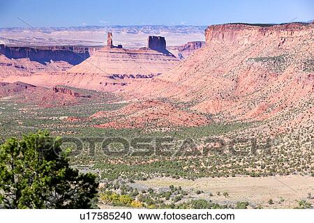 Panorama view of Castle Valley, with butte formation, sweeping valley, green tree in foreground, sunny fall day, with blue sky, Utah View Large Photo Image Stock Image - Panorama view of Castle Valley, with butte formation, sweeping valley, green tree in foreground, sunny fall day, with blue sky, Utah. Fotosearch