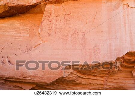 Stock Photo - Red rockface with petroglyphs of figures, Pleasant Valley, Utah. Fotosearch