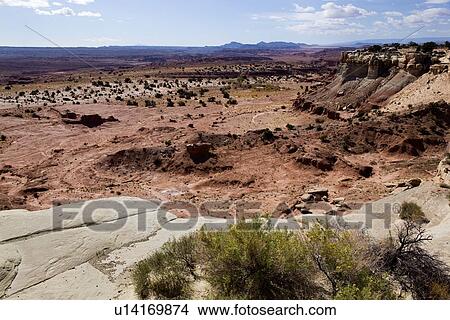 Rocky overlook with valley, distant mountains, blue sky with fluffy white clouds, fall morning, Utah View Large Photo Image Picture - Rocky overlook with valley, distant mountains, blue sky with fluffy white clouds, fall morning, Utah. Fotosearch