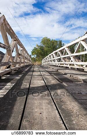 View looking across old wooden bridge crossing San Rafael River, Buckhorn Draw, Utah, on sunny fall morning, with blue sky and puffy white clouds View Large Photo Image Stock Image - View looking across old wooden bridge crossing San Rafael River, Buckhorn Draw, Utah, on sunny fall morning, with blue sky and puffy white clouds. Fotosearch