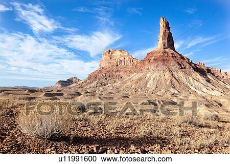 View of Bottleneck Mountain, and mountain range nearby, bushes in foreground, San Rafael Swell on sunny fall morning with blue sky and puffy white clouds, Buckhorn Draw, Utah View Large Photo Image Stock Image - View of Bottleneck Mountain, and mountain range nearby, bushes in foreground, San Rafael Swell on sunny fall morning with blue sky and puffy white clouds, Buckhorn Draw, Utah. Fotosearch