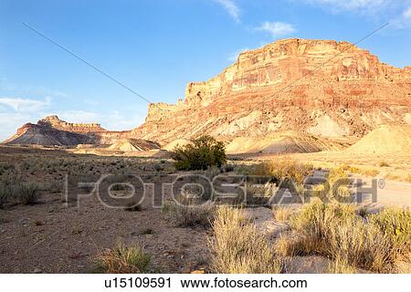 Stock Image - View of Bottleneck Mountain, San Rafael Swell on sunny fall morning with blue sky and puffy white clouds, Buckhorn Draw, Utah. Fotosearch