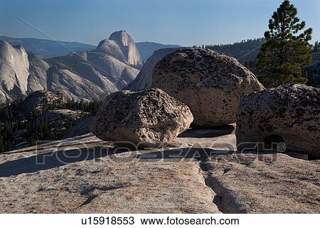 Stock Image - View of Half Dome in late afternoon summer sunlight, across granite trail, Olmsted Point, Yosemite. Fotosearch