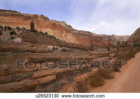 View of traditional old wooden fence and red sandy road, mountain range in distance, sunny afternoon with blue sky, Pleasant Valley, Utah View Large Photo Image Stock Image - View of traditional old wooden fence and red sandy road, mountain range in distance, sunny afternoon with blue sky, Pleasant Valley, Utah. Fotosearch