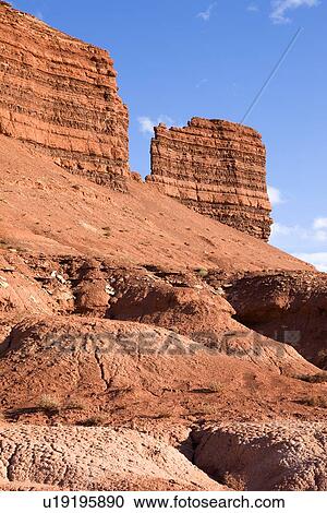Winding gullies leading to red butte formations in Reds Canyon, with blue sky and white clouds, Utah View Large Photo Image Stock Image - Winding gullies leading to red butte formations in Reds Canyon, with blue sky and white clouds, Utah. Fotosearch